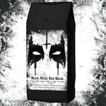 Black coffee bag with black metal design and text on a textured background